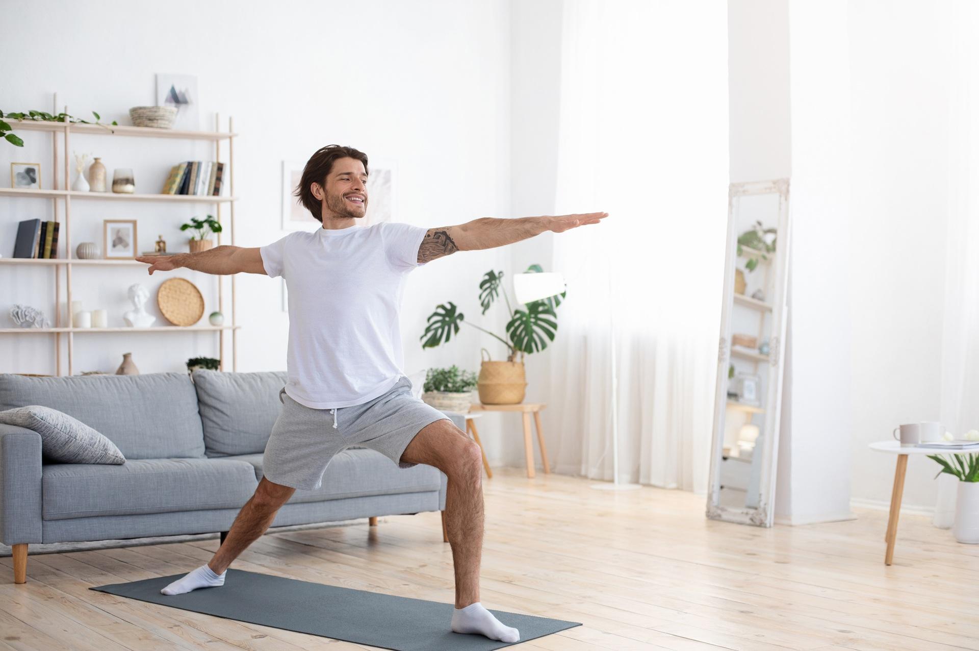 Mann macht Yoga im Wohnzimmer | Enthärtungsanlage